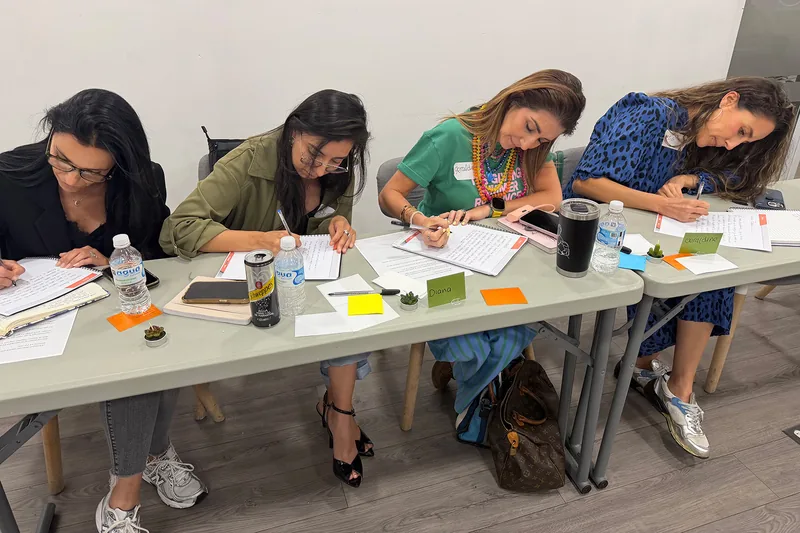 Participantes trabajando en los ejercicios sobre la mesa